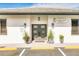 Inviting commercial building entrance with double doors, planters, signage, and well-maintained landscaping at 4256 Rudder Way, New Port Richey, FL 34652