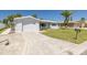 Beautiful single-story home with a driveway, a lush green lawn, and a mature palm tree at 4256 Rudder Way, New Port Richey, FL 34652