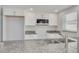 Granite countertops accent the stainless steel appliances and white cabinetry at 4256 Rudder Way, New Port Richey, FL 34652