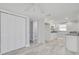 Clean and bright kitchenette with white cabinets, modern appliances, and a closet at 4256 Rudder Way, New Port Richey, FL 34652