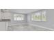 Kitchenette with white cabinetry overlooking the breakfast room at 4256 Rudder Way, New Port Richey, FL 34652