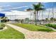 Beautiful marina with lush green lawn, brick walkway, sailboats, and mature palm trees, perfect for relaxation at 4256 Rudder Way, New Port Richey, FL 34652