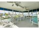 Covered patio with multiple tables and chairs and a beautiful view of the water at 4256 Rudder Way, New Port Richey, FL 34652
