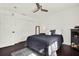 Cozy bedroom with dark wood floors, ceiling fan, and comfortable furnishings, creating a relaxing atmosphere at 5007 Starfish Se Dr # A, St Petersburg, FL 33705