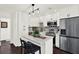 Modern kitchen featuring white cabinets, stainless steel appliances, and a stylish center island at 5007 Starfish Se Dr # A, St Petersburg, FL 33705