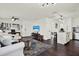 Comfortable living room open to kitchen, featuring hardwood floors and contemporary decor at 5007 Starfish Se Dr # A, St Petersburg, FL 33705