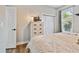 Comfortable bedroom with light colored dresser, closet, and natural light from a window at 5416 Twin Creeks Dr, Valrico, FL 33596