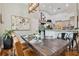 Dining room featuring a wooden table, modern light fixture, and views into the kitchen at 5416 Twin Creeks Dr, Valrico, FL 33596