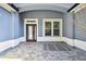 Covered entryway featuring a tiled floor, a front door, and a window at 5416 Twin Creeks Dr, Valrico, FL 33596