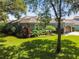 Well-maintained home with mature trees, lush landscaping, and a manicured lawn at 5416 Twin Creeks Dr, Valrico, FL 33596