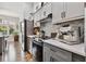 Beautiful kitchen with stainless steel appliances, gray cabinets, and a stylish backsplash at 5416 Twin Creeks Dr, Valrico, FL 33596