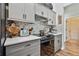 Well-appointed kitchen featuring stainless steel appliances, gray cabinets, and modern countertops at 5416 Twin Creeks Dr, Valrico, FL 33596