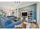 Open-concept living room features hardwood floors, a modern entertainment center, and comfortable seating at 5416 Twin Creeks Dr, Valrico, FL 33596