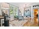 Cozy living room with hardwood floors, large windows, and a comfortable armchair at 5416 Twin Creeks Dr, Valrico, FL 33596