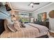 Comfortable main bedroom featuring soft lighting, dark wood furniture, and access to outdoor space at 5416 Twin Creeks Dr, Valrico, FL 33596