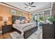 Cozy main bedroom with a ceiling fan, wood furniture, and a sliding door to the backyard at 5416 Twin Creeks Dr, Valrico, FL 33596