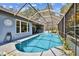 Inviting screened pool with waterfall feature and ample deck space for relaxing and entertaining at 5416 Twin Creeks Dr, Valrico, FL 33596