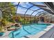Sparkling pool with a spa and waterfall feature, surrounded by lush tropical landscaping at 5416 Twin Creeks Dr, Valrico, FL 33596