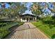 A charming community clubhouse with manicured landscaping and a pathway leading to the entrance at 5416 Twin Creeks Dr, Valrico, FL 33596
