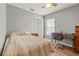 Bedroom with laminate floors, neutral walls and a desk at 5902 War Admiral Dr, Wesley Chapel, FL 33544