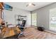 Bright bedroom with hardwood floors, a ceiling fan, and a stylish rustic desk at 5902 War Admiral Dr, Wesley Chapel, FL 33544