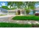Charming single-story home with a well-manicured lawn, two-car garage and beautiful columns at the front door at 5902 War Admiral Dr, Wesley Chapel, FL 33544