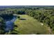 Expansive golf course with mature trees, pristine green, sand traps, and tranquil water hazard at 5902 War Admiral Dr, Wesley Chapel, FL 33544