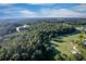 Gorgeous aerial view of the golf course, serene water features, mature trees, and the meticulously landscaped community at 5902 War Admiral Dr, Wesley Chapel, FL 33544