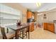Kitchen with a dining table, light countertops, and wood cabinets, offering a cozy space to dine at 5902 War Admiral Dr, Wesley Chapel, FL 33544
