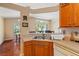 Corner view of the kitchen with double basin sink and view into other dining spaces at 5902 War Admiral Dr, Wesley Chapel, FL 33544