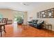 Comfortable living area with ample seating, wood floors, and view to the backyard at 5902 War Admiral Dr, Wesley Chapel, FL 33544