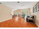 Spacious living room featuring wood floors, comfortable seating, and natural light from large windows at 5902 War Admiral Dr, Wesley Chapel, FL 33544
