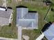 Aerial view displays the roofline, landscaping, and the overall layout of the property in the neighborhood at 703 Bel Air Ave, Sun City Center, FL 33573
