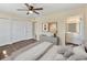 Bedroom features a closet and an ensuite bathroom, with a sleek gray cabinet and contemporary artwork displayed at 703 Bel Air Ave, Sun City Center, FL 33573