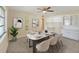 Cozy dining room featuring a modern table setting, neutral decor, and bright lighting at 703 Bel Air Ave, Sun City Center, FL 33573