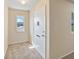 Inviting front entrance featuring neutral tones, carpet flooring, and a storm door at 703 Bel Air Ave, Sun City Center, FL 33573