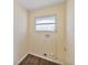 Functional laundry room features a window for ventilation and essential plumbing connections for appliances at 703 Bel Air Ave, Sun City Center, FL 33573