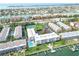 Expansive aerial view of waterfront condos with a pool, tennis court and Gulf views at 719 Pinellas Bayway S # 309, Tierra Verde, FL 33715