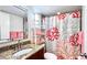 Bathroom featuring granite countertops, a large mirror, and coral themed shower curtain at 719 Pinellas Bayway S # 309, Tierra Verde, FL 33715