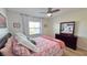 Bedroom featuring a ceiling fan, a window and a dresser with large mirror at 719 Pinellas Bayway S # 309, Tierra Verde, FL 33715