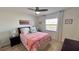 Bedroom featuring a ceiling fan, a window with blinds and coastal decorations at 719 Pinellas Bayway S # 309, Tierra Verde, FL 33715