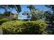 Community entrance sign at 719 Tierra I, surrounded by lush greenery and tropical plants at 719 Pinellas Bayway S # 309, Tierra Verde, FL 33715