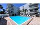 Beautiful community pool area with lounge chairs and surrounding condos, great for leisure and socializing at 719 Pinellas Bayway S # 309, Tierra Verde, FL 33715