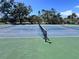 Well-maintained tennis court with vibrant blue and green playing surface and a sturdy net at 719 Pinellas Bayway S # 309, Tierra Verde, FL 33715