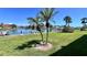 Scenic backyard with lush lawn and lovely waterfront view at 719 Pinellas Bayway S # 309, Tierra Verde, FL 33715