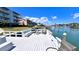 Beautiful waterfront deck with seating and views of the harbor and nearby condos at 719 Pinellas Bayway S # 309, Tierra Verde, FL 33715
