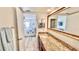 Bright bathroom with granite countertop vanity and a view into an adjacent bedroom at 719 Pinellas Bayway S # 309, Tierra Verde, FL 33715