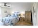 Comfortable bedroom with coastal-themed bedding, wood-look floors, and classic furnishings at 719 Pinellas Bayway S # 309, Tierra Verde, FL 33715