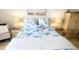 Inviting bedroom with beach-themed decor, side tables with lamps, and warm, neutral walls at 719 Pinellas Bayway S # 309, Tierra Verde, FL 33715