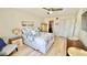 Bright and spacious bedroom with light wood floors, ceiling fan, and neutral decor at 719 Pinellas Bayway S # 309, Tierra Verde, FL 33715